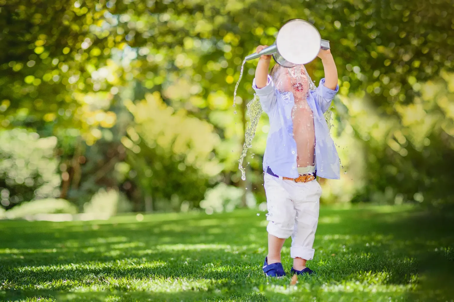 a child pouring water from a watering can