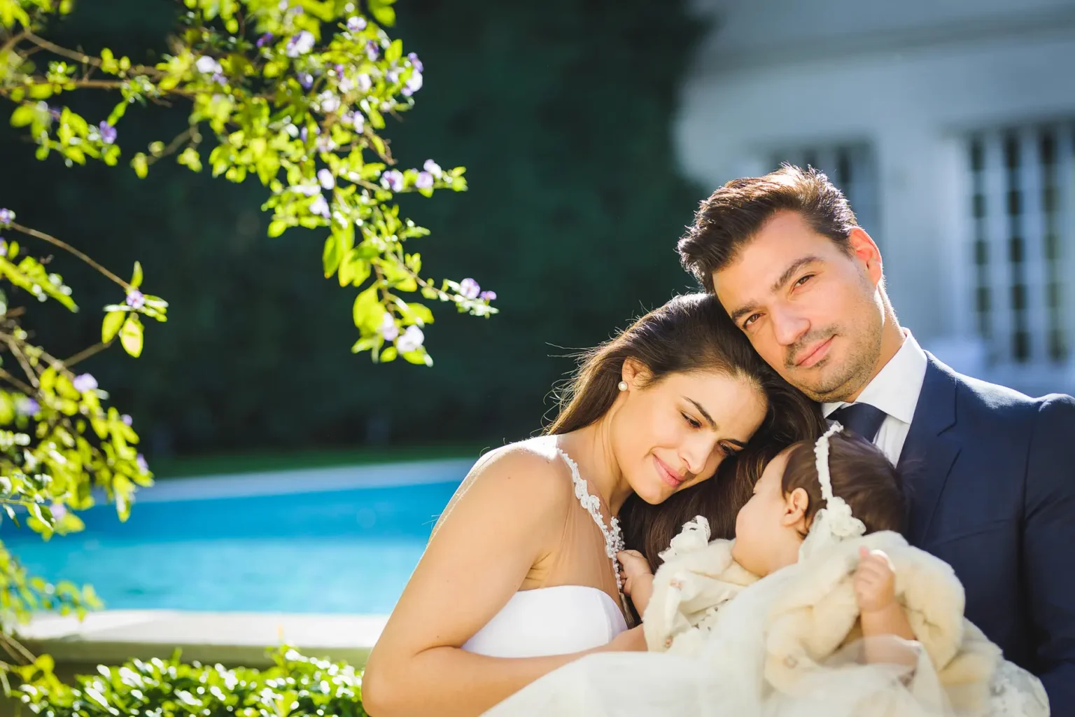 a man and woman holding a baby