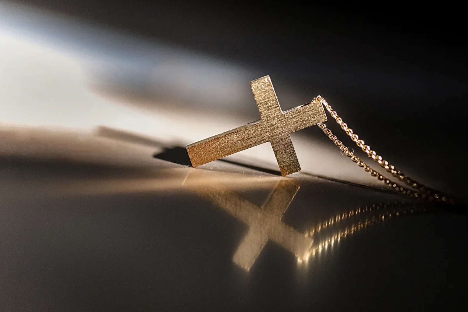 a gold cross on a chain