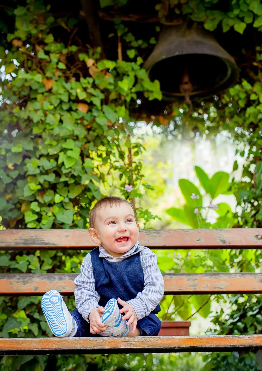 a baby sitting on a bench