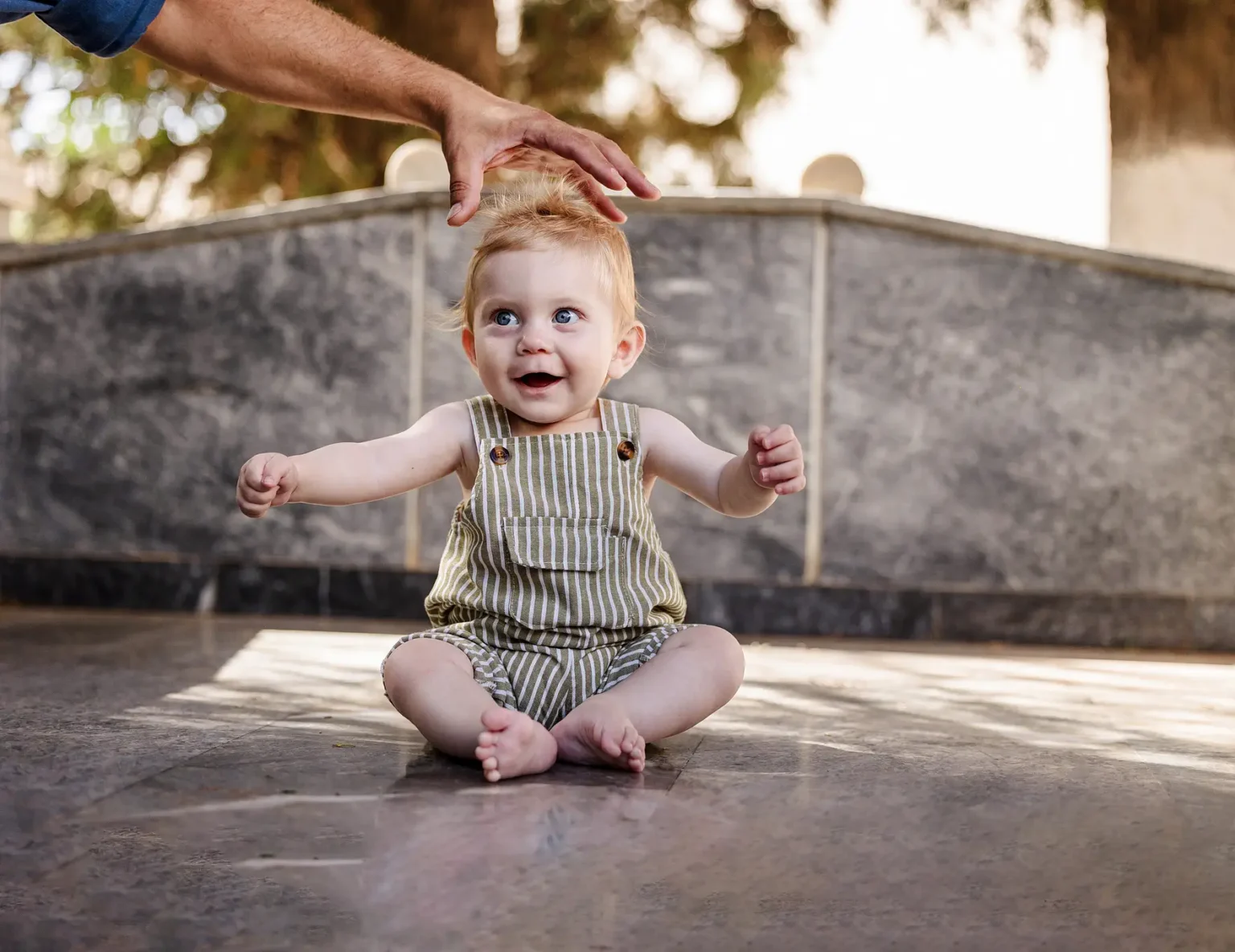 a baby sitting on the ground