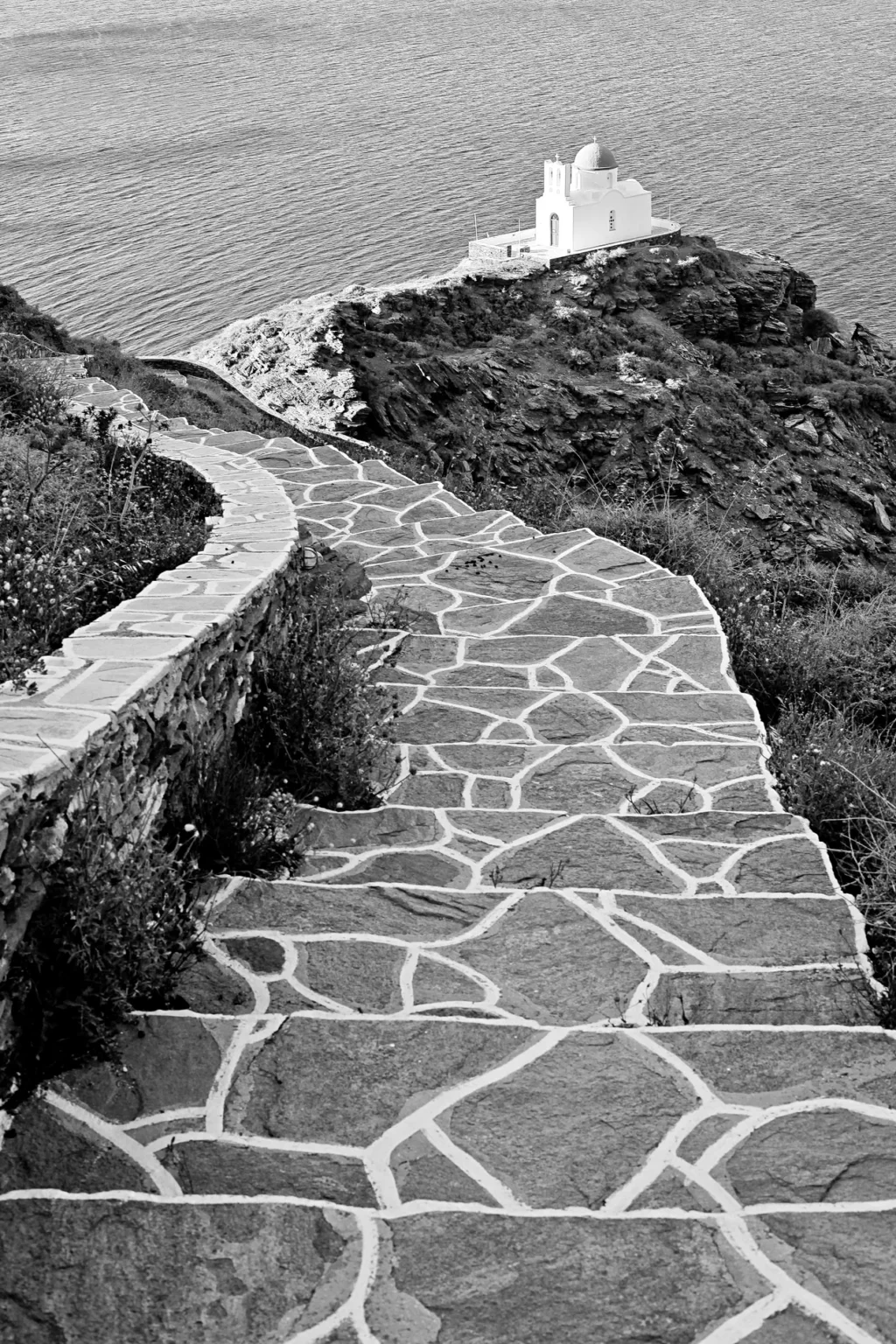 a stone path leading to a lighthouse