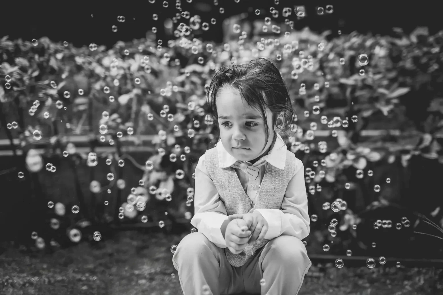 a child sitting in front of bubbles