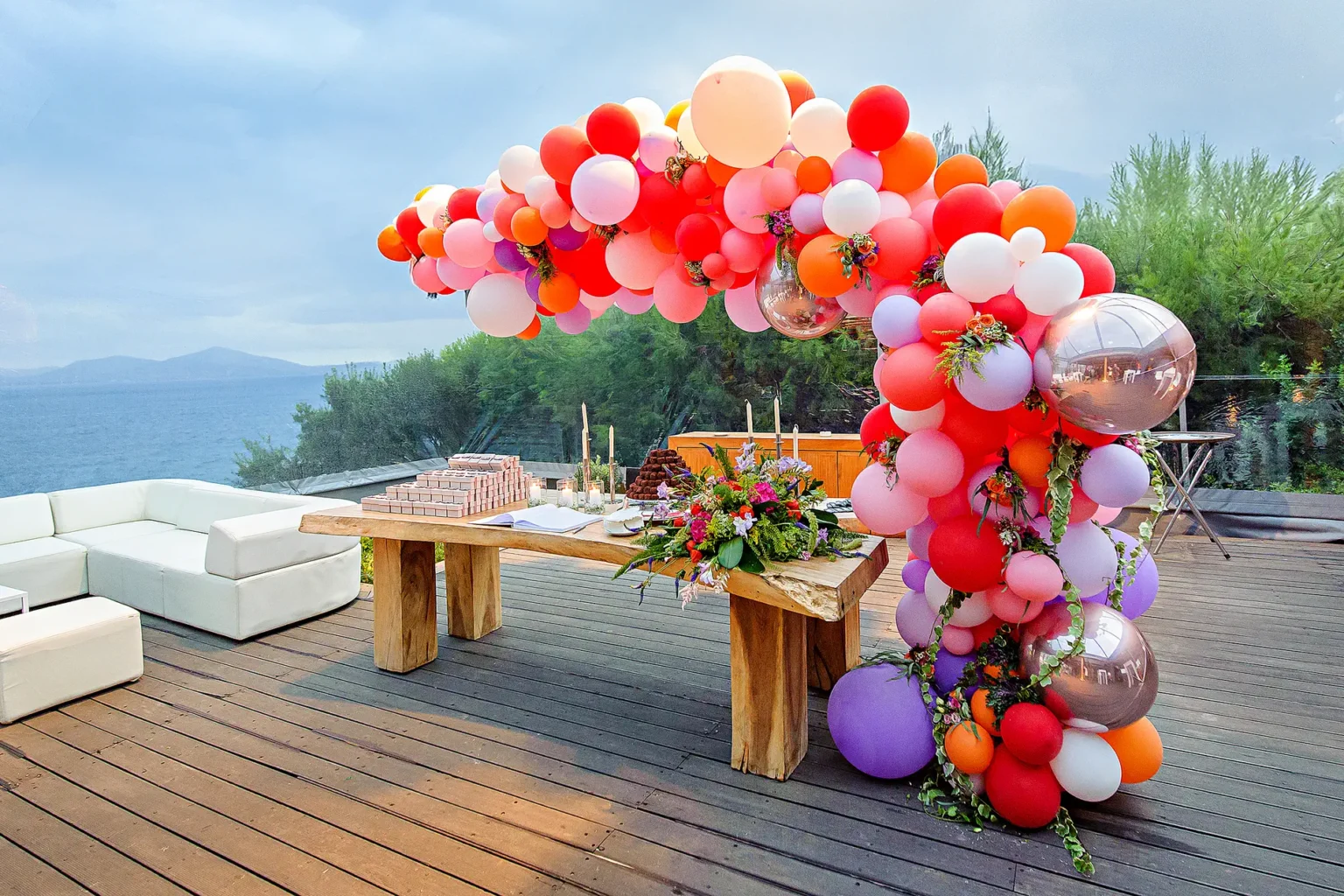 a table with balloons and flowers on it