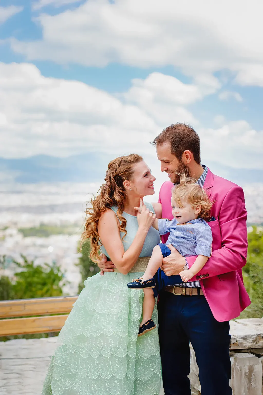 a man and woman holding a baby