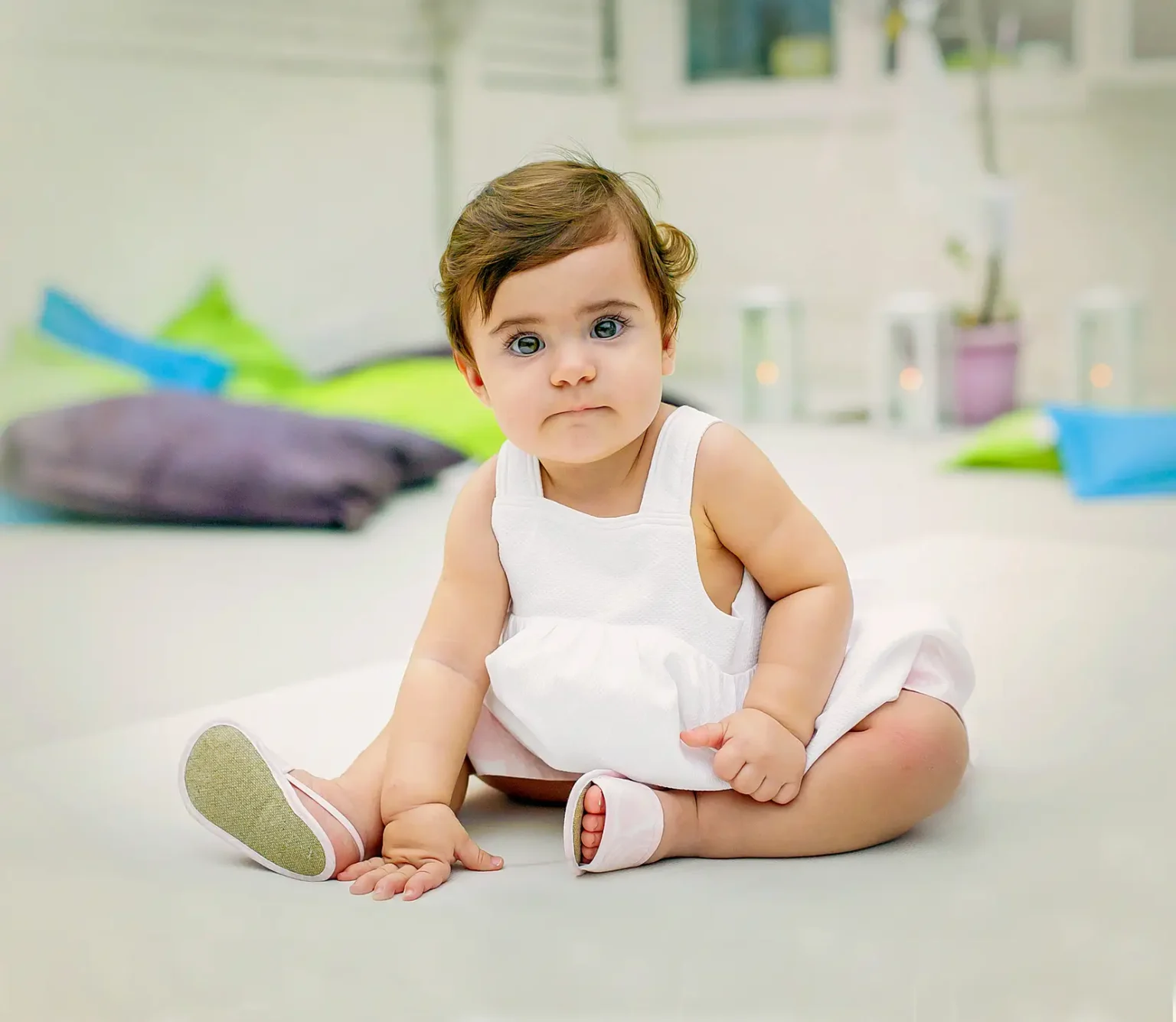 a baby sitting on the floor