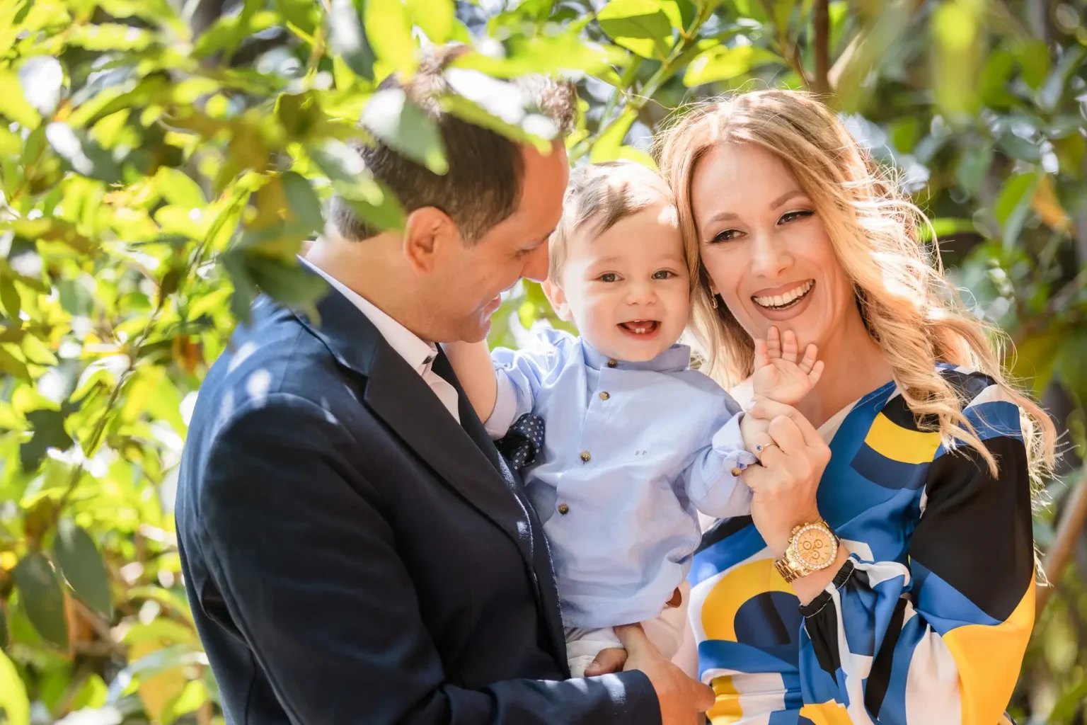 a man and woman holding a baby