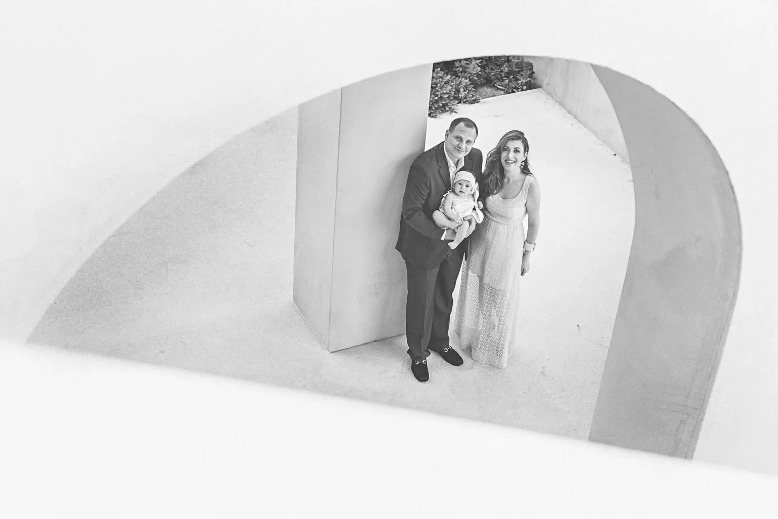 a man and woman holding a baby