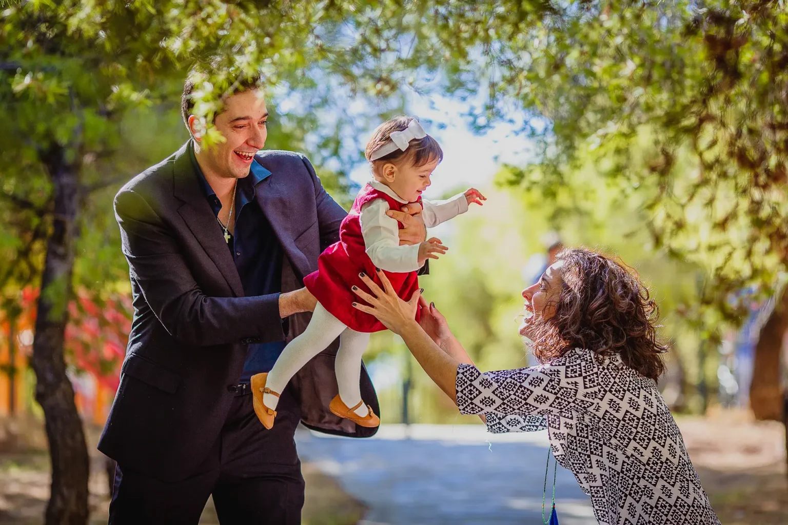 a man and woman holding a baby