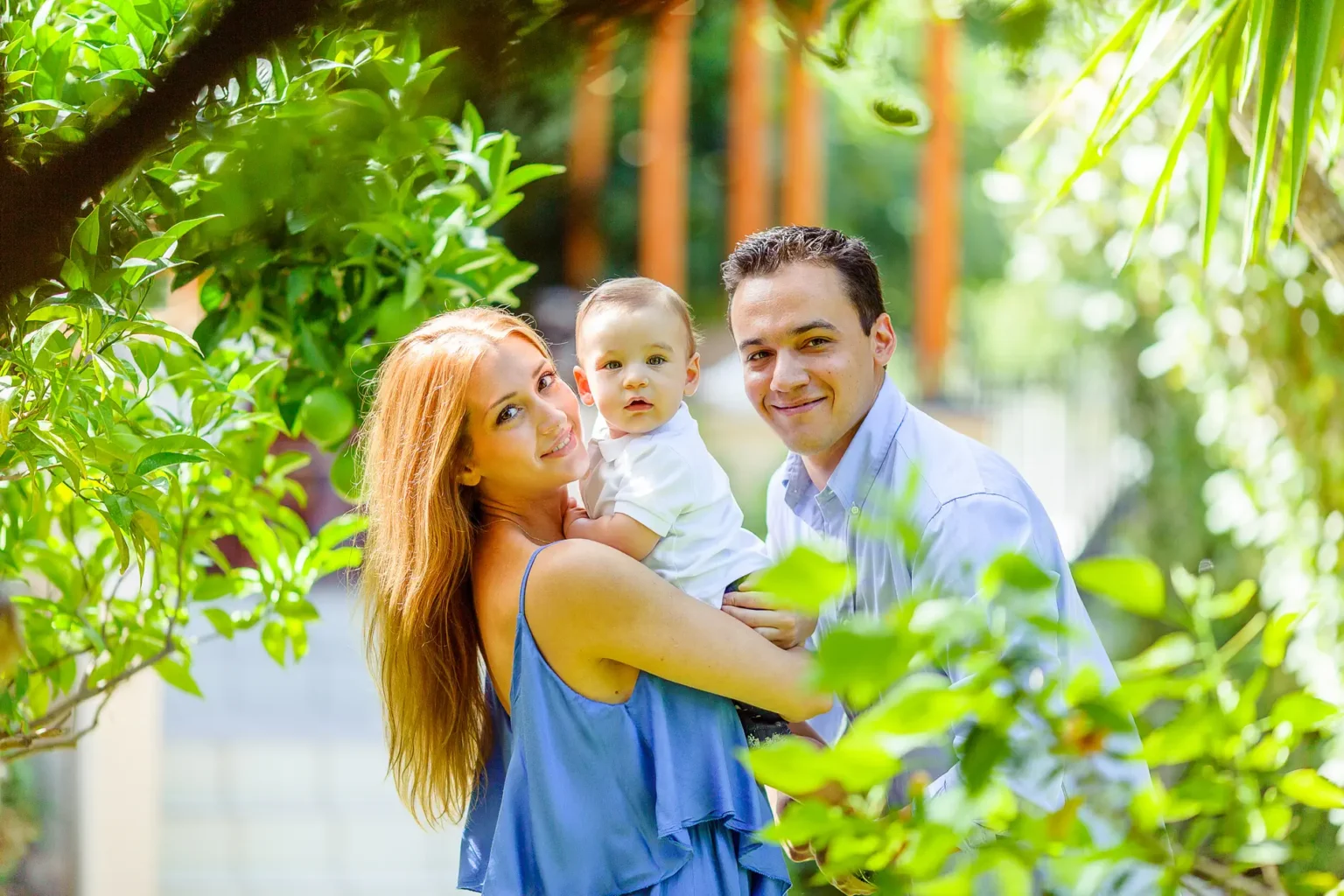 a man and woman holding a baby
