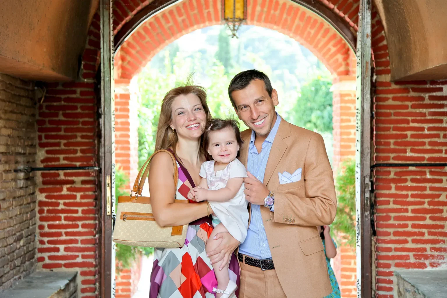 a man and woman holding a baby