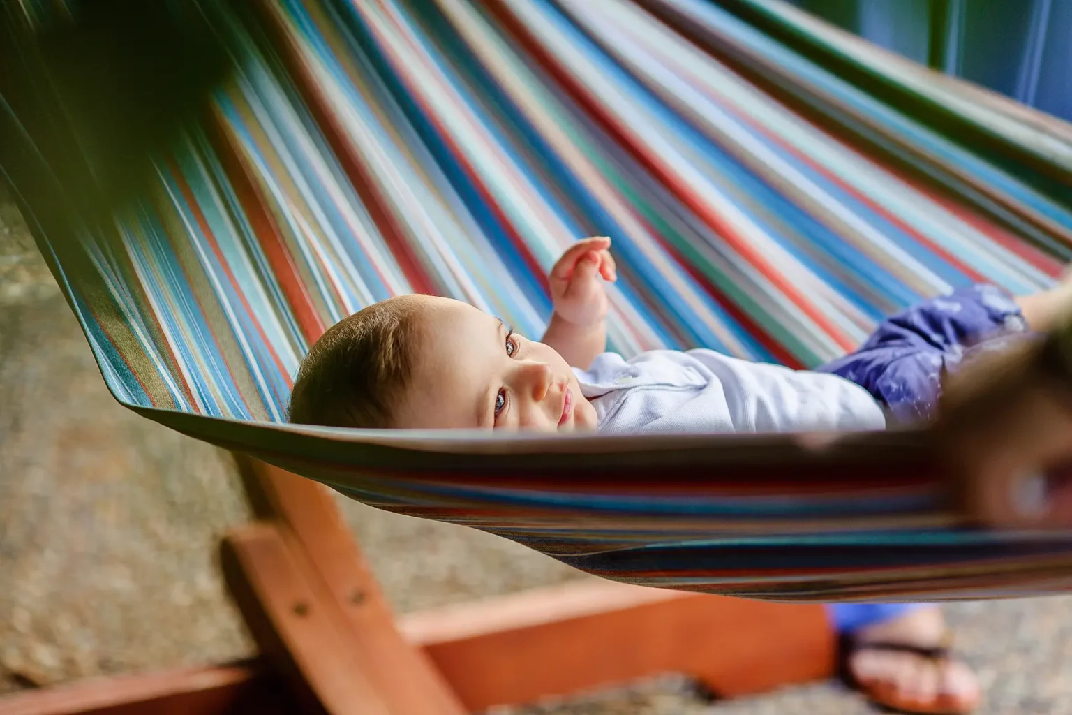 a child lying in a hammock
