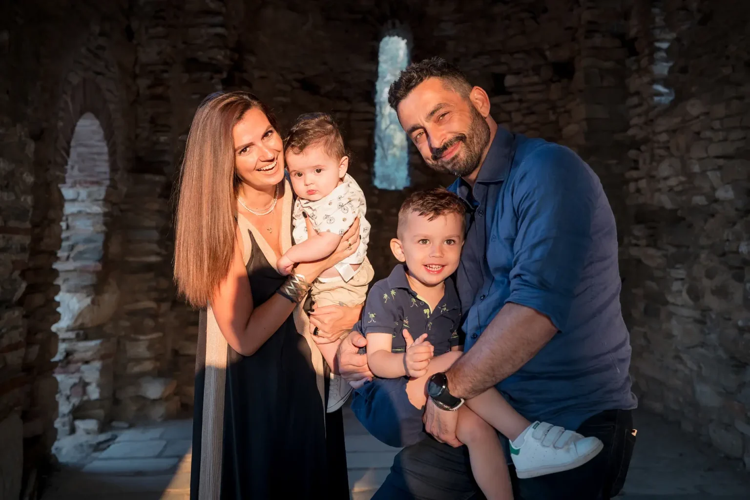 a man and woman holding two children