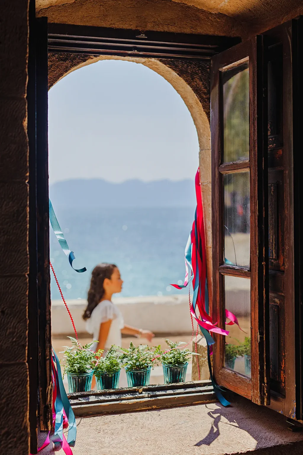 a window with a woman in the background