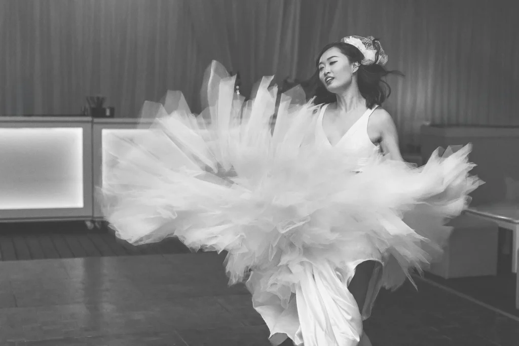 a woman in a white dress dancing