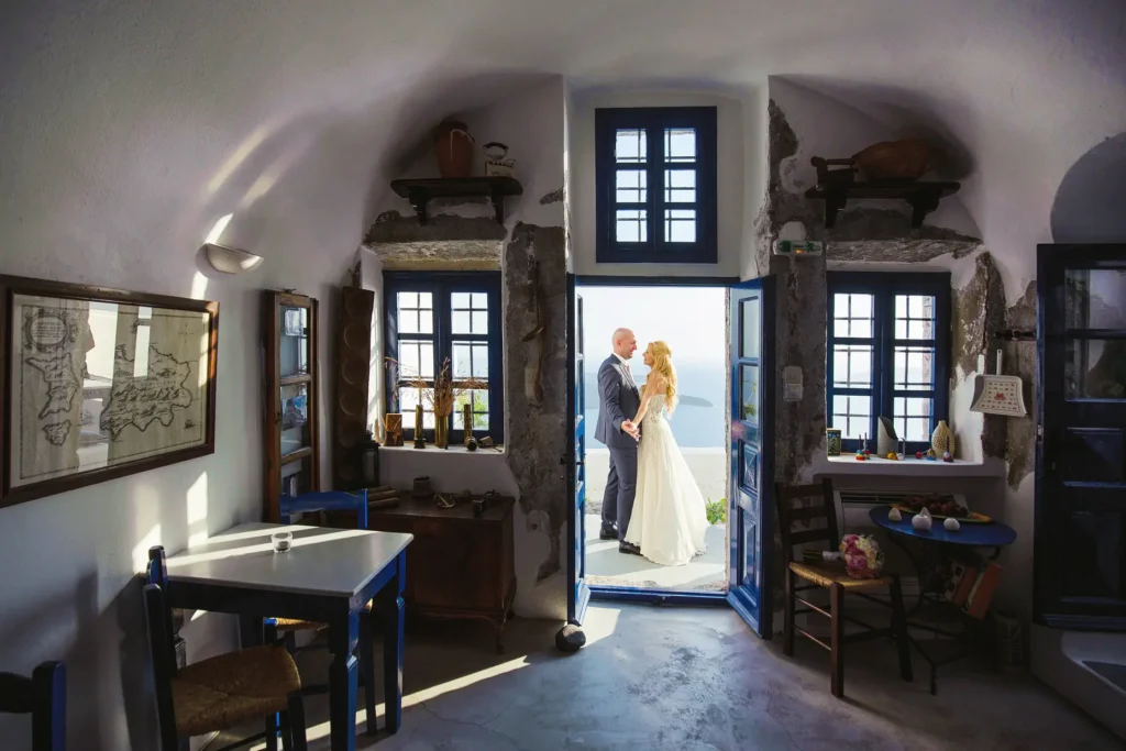 a man and woman standing in a room with blue windows
